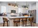 Well-lit kitchen featuring stainless steel appliances, a kitchen island with bar stools, and ample counter space at 6543 Orange Cream Aly, Winter Garden, FL 34787