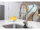 Close-up of a kitchen sink with a modern faucet and marble countertops at 6543 Orange Cream Aly, Winter Garden, FL 34787