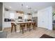 Bright kitchen features a central island with seating, stainless steel appliances, and white cabinets and countertops at 6543 Orange Cream Aly, Winter Garden, FL 34787