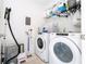 Well-organized laundry room with washer, dryer, shelving, and cleaning supplies at 6543 Orange Cream Aly, Winter Garden, FL 34787