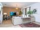Open-concept living room featuring a large sofa, stylish decor, and ample natural light at 6543 Orange Cream Aly, Winter Garden, FL 34787