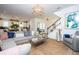 Open-concept living room showcasing modern decor, a jute rug, and an abundance of natural light at 6543 Orange Cream Aly, Winter Garden, FL 34787