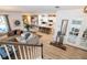 Open-concept living space with modern decor, wood-look flooring, and seamless flow to the kitchen at 6543 Orange Cream Aly, Winter Garden, FL 34787