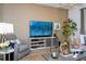 Cozy living room area with a mounted TV, comfortable seating, and stylish decor at 6543 Orange Cream Aly, Winter Garden, FL 34787