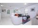 Bright living room with comfortable seating, stylish decor, and abundant natural light creates inviting space at 6543 Orange Cream Aly, Winter Garden, FL 34787