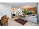 Spacious living area with wood-look tile flooring, stylish furnishings, and a view of the staircase at 6543 Orange Cream Aly, Winter Garden, FL 34787