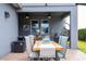 Covered outdoor patio with a dining table, chairs, ceiling fans, and an outdoor lounge area at 6543 Orange Cream Aly, Winter Garden, FL 34787