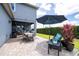Cozy patio features a dining table, chairs, an umbrella, and beautiful plants at 6543 Orange Cream Aly, Winter Garden, FL 34787