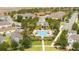 Aerial view of a community pool and amenity center surrounded by palm trees and landscaping at 6543 Orange Cream Aly, Winter Garden, FL 34787