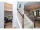 Carpeted staircase with white banisters and wooden handrails leads to the upper level at 6543 Orange Cream Aly, Winter Garden, FL 34787