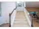 The carpeted staircase features white railings and wooden handrails leading upstairs at 6543 Orange Cream Aly, Winter Garden, FL 34787