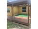 Back porch with wooden deck and artificial turf beneath a covered patio space at 701 Twin Lake Ave, Deltona, FL 32738