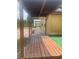 Relaxing back porch with wooden deck under a covered roof leading to backyard shed at 701 Twin Lake Ave, Deltona, FL 32738