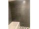 Modern bathroom with dark tile, stylish fixtures and bathtub at 701 Twin Lake Ave, Deltona, FL 32738