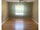 Bedroom with neutral walls, ceiling fan, window and hardwood floors at 701 Twin Lake Ave, Deltona, FL 32738
