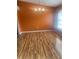 Bright dining room featuring wood floors, an orange accent wall, and a modern chandelier at 701 Twin Lake Ave, Deltona, FL 32738