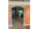 Hallway with neutral tile floors with rustic archway at 701 Twin Lake Ave, Deltona, FL 32738