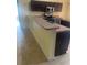 Kitchen with breakfast bar, black appliances, and an island providing ample cooking space at 701 Twin Lake Ave, Deltona, FL 32738