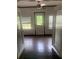Open living room with hardwood floors and a glass paneled back door provides an outdoor view at 701 Twin Lake Ave, Deltona, FL 32738