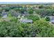 Aerial view highlighting the property within its neighborhood, surrounded by lush trees and greenery at 711 Valencia Ct, Winter Garden, FL 34787