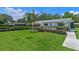 Lush backyard featuring a well-maintained lawn, manicured hedges, and an outdoor hot tub at 711 Valencia Ct, Winter Garden, FL 34787