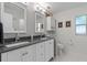 Bright bathroom features a double sink vanity, updated lighting, and updated hardware at 711 Valencia Ct, Winter Garden, FL 34787