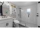 Modern bathroom with glass shower, black and white patterned tile floors, and white vanity at 711 Valencia Ct, Winter Garden, FL 34787