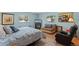 Bedroom with wood floors, 2 windows, a couch, and a leather recliner at 711 Valencia Ct, Winter Garden, FL 34787