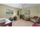Bright bedroom features a large window, light-colored floors, and a seating area with fitness equipment at 711 Valencia Ct, Winter Garden, FL 34787