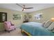 Bright bedroom featuring a ceiling fan, two windows, and stylish decor creating a cozy, inviting space at 711 Valencia Ct, Winter Garden, FL 34787