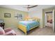 Bedroom featuring wood floors, a bright yellow bed frame, a ceiling fan, and a pink arm chair at 711 Valencia Ct, Winter Garden, FL 34787