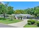 Beautiful home with a spacious driveway, two-car garage, and lush landscaping, creating excellent curb appeal at 711 Valencia Ct, Winter Garden, FL 34787