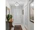 Inviting foyer showcasing a decorative table, elegant lighting, and a glimpse of the home's interior at 711 Valencia Ct, Winter Garden, FL 34787
