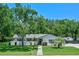 Charming single-story home featuring a well-manicured lawn, mature trees, and a welcoming front entrance at 711 Valencia Ct, Winter Garden, FL 34787