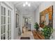 Hallway featuring tile flooring, decorative mirror, and a glimpse into the living space at 711 Valencia Ct, Winter Garden, FL 34787