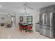 Updated kitchen boasts stainless steel appliances, an eat-in dining area, and tile flooring at 711 Valencia Ct, Winter Garden, FL 34787