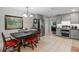 Eat-in kitchen with stainless steel appliances, gray cabinets, and an adjacent dining area at 711 Valencia Ct, Winter Garden, FL 34787