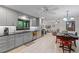 Renovated kitchen with tile floors, updated appliances, black countertops, and gray cabinetry at 711 Valencia Ct, Winter Garden, FL 34787