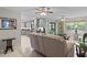 Comfortable living room showcases tile flooring, ceiling fans and a view into the renovated kitchen at 711 Valencia Ct, Winter Garden, FL 34787