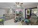 Spacious living room features tile flooring and a view into the renovated kitchen and dining area at 711 Valencia Ct, Winter Garden, FL 34787