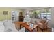 Bright and airy living room featuring comfortable seating, tile floors, and ample natural light at 711 Valencia Ct, Winter Garden, FL 34787