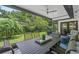 Screened patio overlooking a lush green yard with seating for dining and relaxation at 711 Valencia Ct, Winter Garden, FL 34787