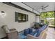 Screened patio with comfortable seating and an outdoor dining area perfect for relaxing and entertaining at 711 Valencia Ct, Winter Garden, FL 34787