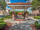 A charming town square gazebo with landscaped walkways and vibrant shops in the background at 711 Valencia Ct, Winter Garden, FL 34787
