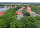 Aerial shot showcasing residential neighborhood with lush greenery near a picturesque lake at 7698 Mount Carmel Dr, Orlando, FL 32835