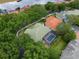 Aerial view of property in residential area with tree lined streets and serene lake at 7698 Mount Carmel Dr, Orlando, FL 32835