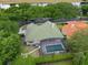 Aerial view showing a house with a green tile roof and a private screened-in pool at 7698 Mount Carmel Dr, Orlando, FL 32835
