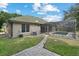 View of the house and backyard pool featuring a paved walkway, lush green grass, and blue sky at 7698 Mount Carmel Dr, Orlando, FL 32835