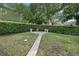 Private backyard featuring beautiful landscaping, a brick path, and manicured hedges at 7698 Mount Carmel Dr, Orlando, FL 32835