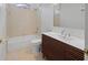 Bathroom featuring a tub, a sink with modern cabinet, and tiled walls at 7698 Mount Carmel Dr, Orlando, FL 32835
